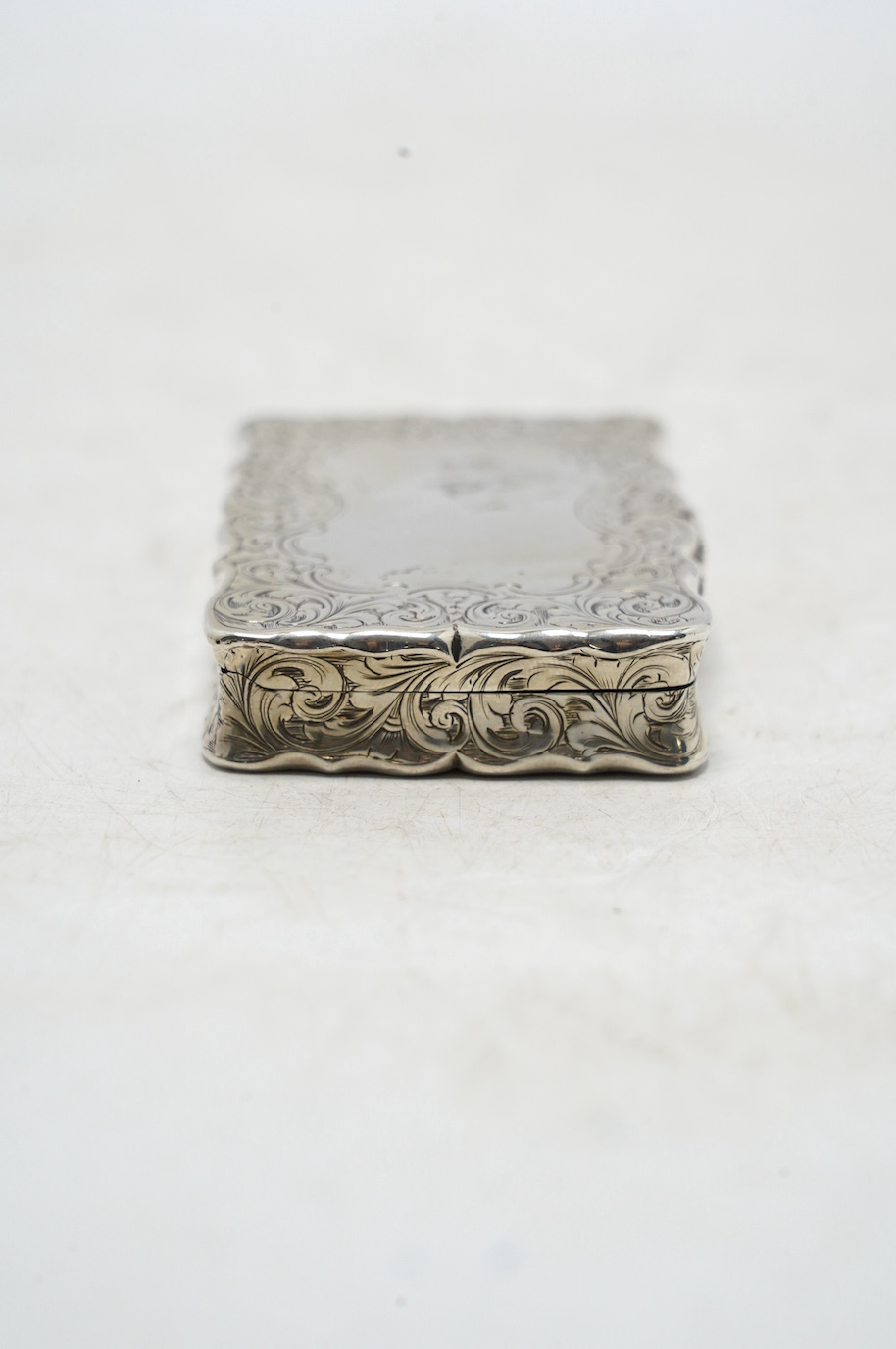 A Victorian engraved silver snuff box, by Nathaniel Mills, Birmingham, 1851, 66mm. Condition - fair